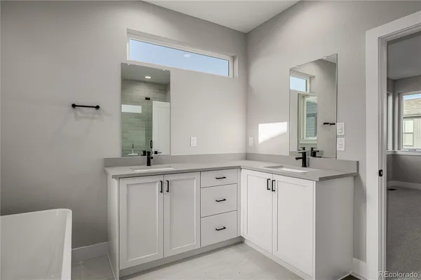 a spacious bathroom with a granite countertop sink and a mirror