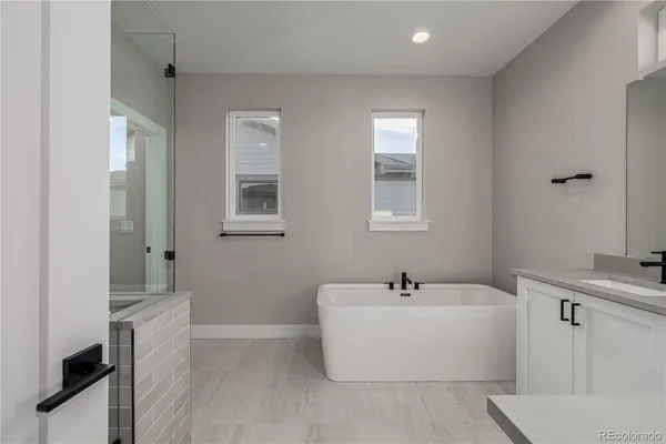 a white bath tub sitting next to a white sink