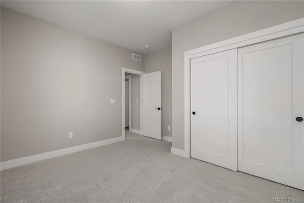 a view of an empty room and closet area