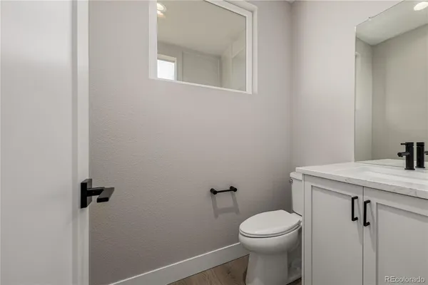 a white toilet sitting next to a white sink
