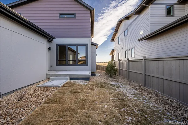a view of a house with a small backyard