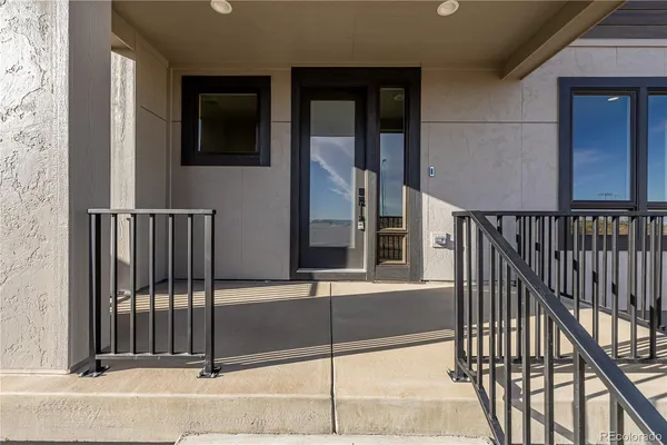 a view of a house with a floor to ceiling window and stairs