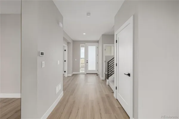 a view of a hallway with wooden floor