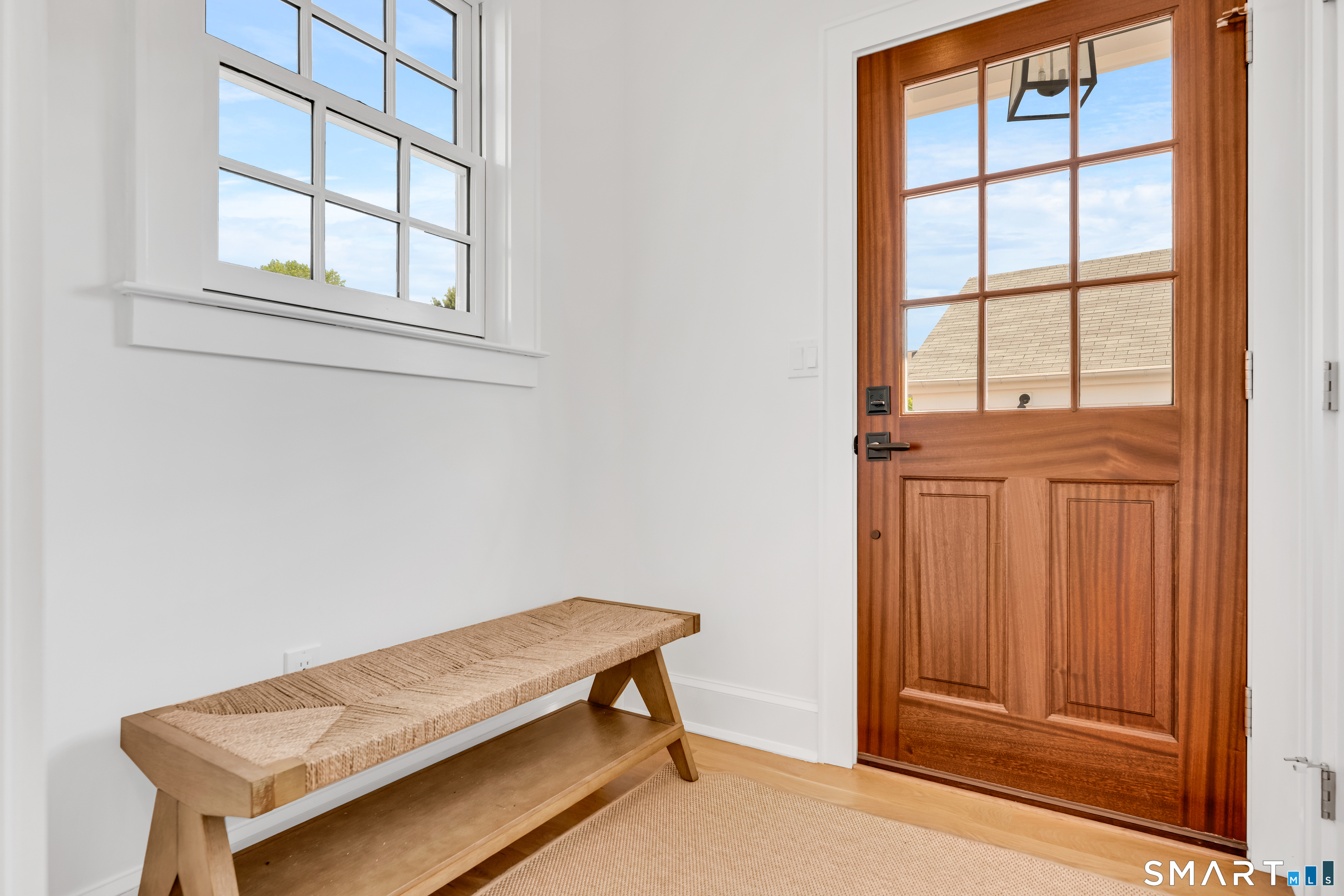 920 Old Post Road Fairfield, CT 06824 - Photo 31 of 40 The mudroom is perfectly sized, just off the kitchen. Large closet and mahogany door.