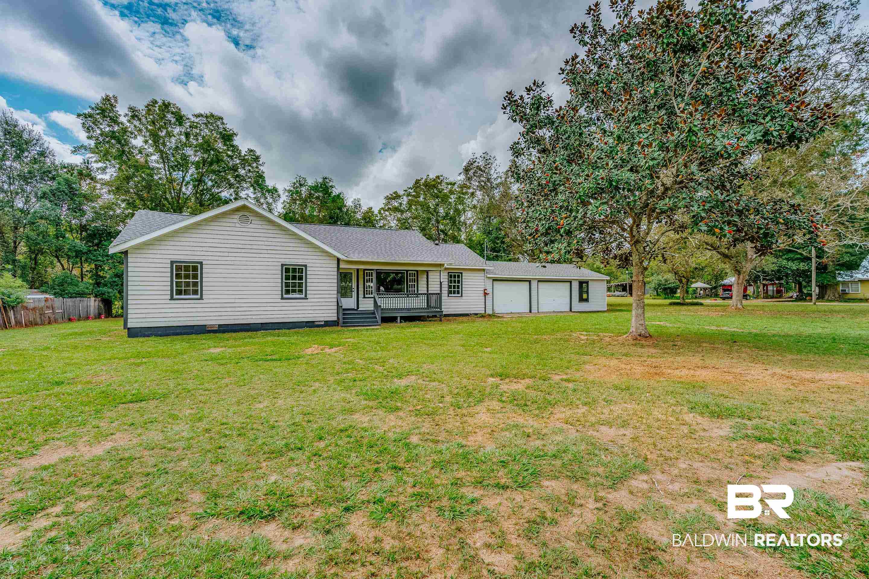 8001 16th Street Irvington, AL 36544 - Photo 32 of 35 Rear view of house featuring a yard, crawl space, and a garage