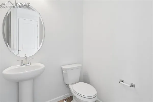 a white toilet sitting next to a bathroom sink