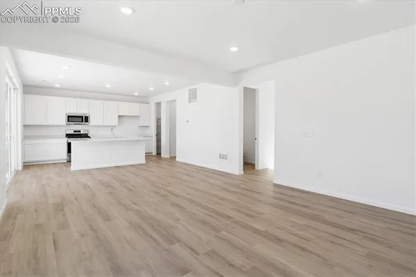 a view of a kitchen with a sink and a refrigerator