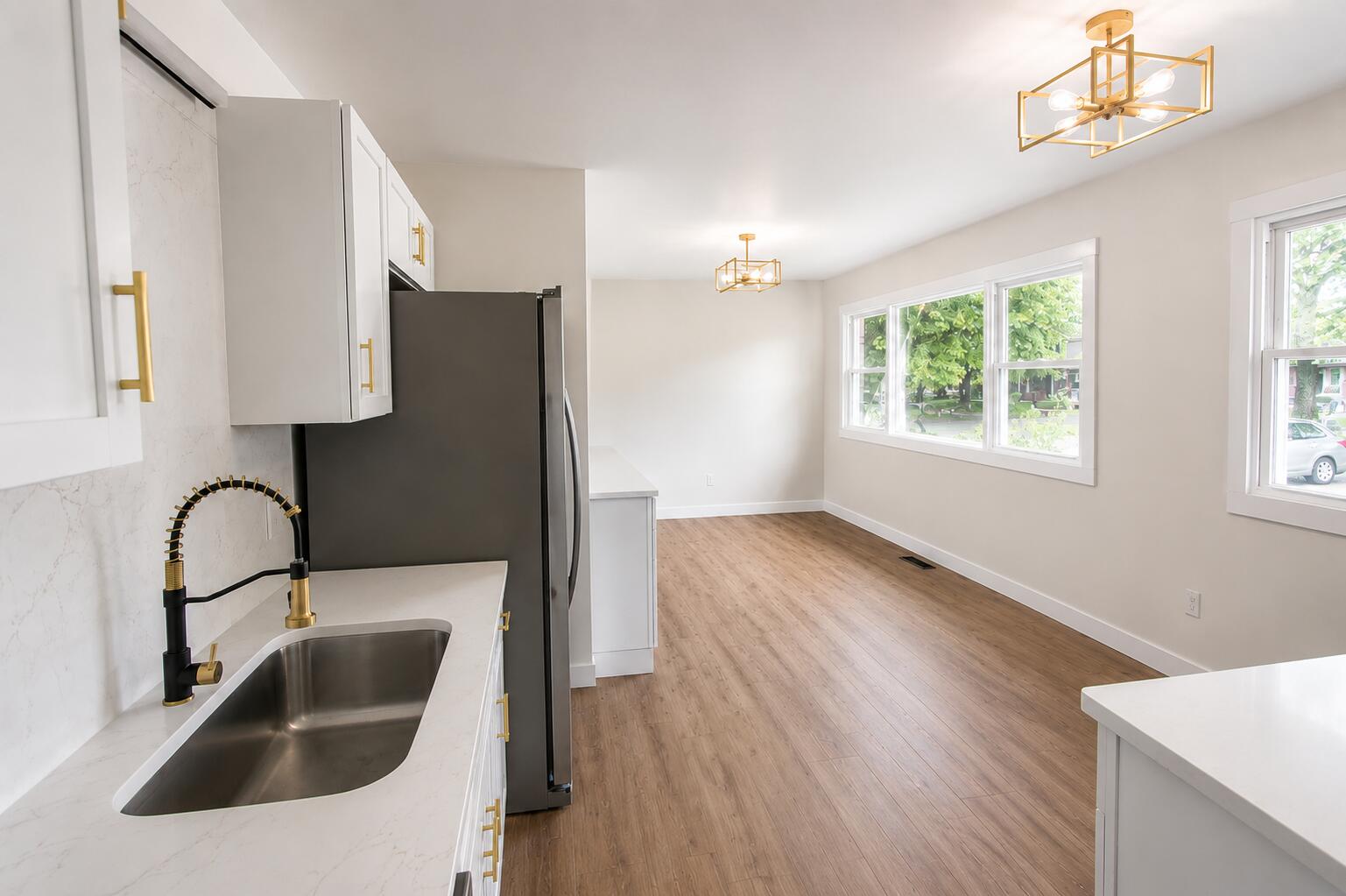 414 Holly Road Michigan City, IN 46360 - Photo 11 of 41 a kitchen with a sink and a refrigerator