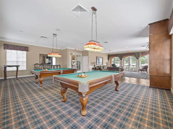 a living room with furniture a table and a chandelier