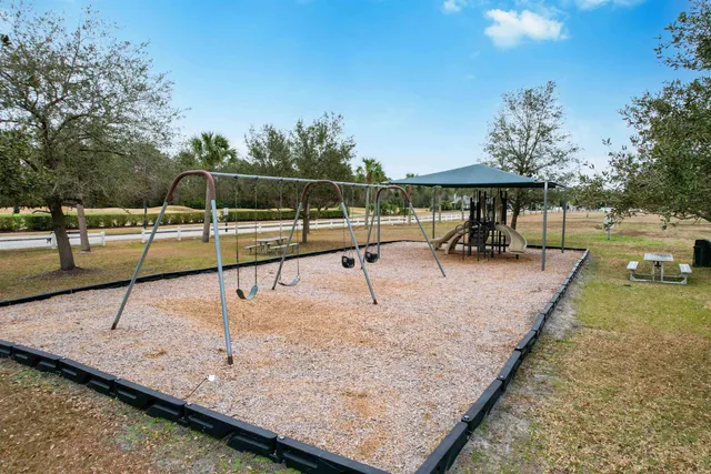 a view of a backyard with swimming pool