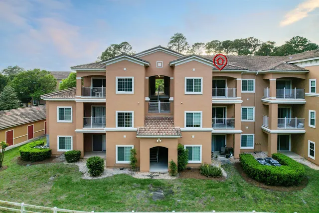 a view of a brick building next to a yard
