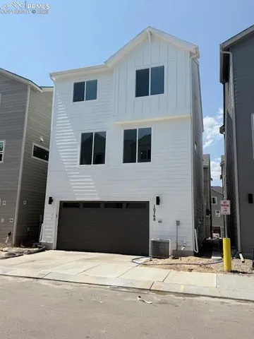 a view of kitchen with wooden floor and electronic appliances
