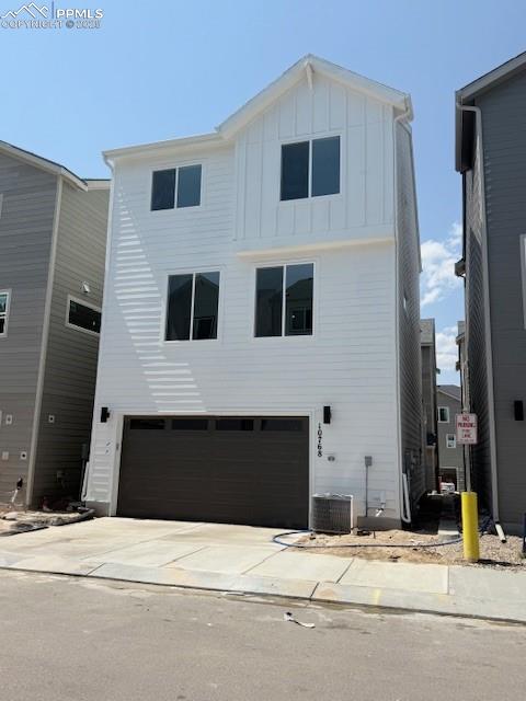 10768 Lewanee Point Colorado Springs, CO 80908 - Photo 2 of 32 Rear view of property with an attached garage, board and batten siding, and concrete driveway