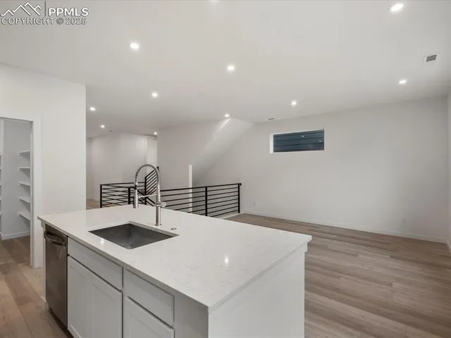 a kitchen with kitchen island a sink stainless steel appliances and refrigerator