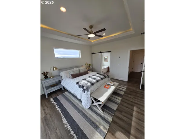 a en suite bathroom with a granite countertop sink and a mirror