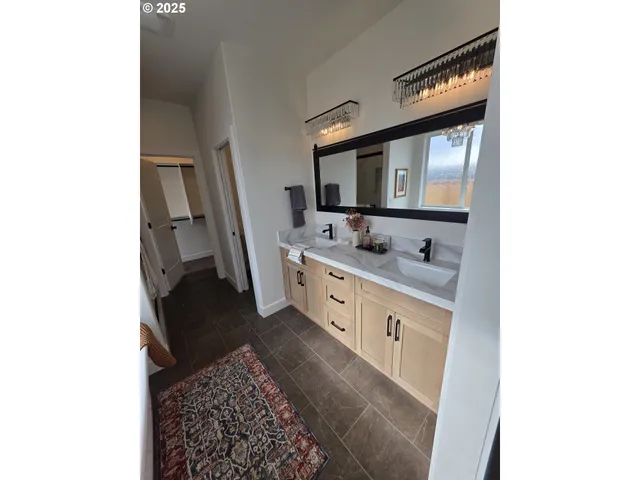 a kitchen with stainless steel appliances a dining table chairs stove refrigerator and cabinets