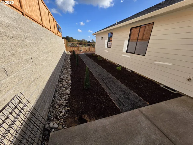 a backyard of a house with yard fire pit barbeque oven and outdoor seating