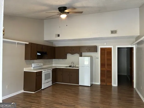 a kitchen with stainless steel appliances granite countertop a stove and a refrigerator