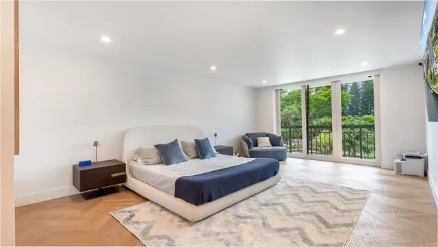 a living room with furniture and large windows