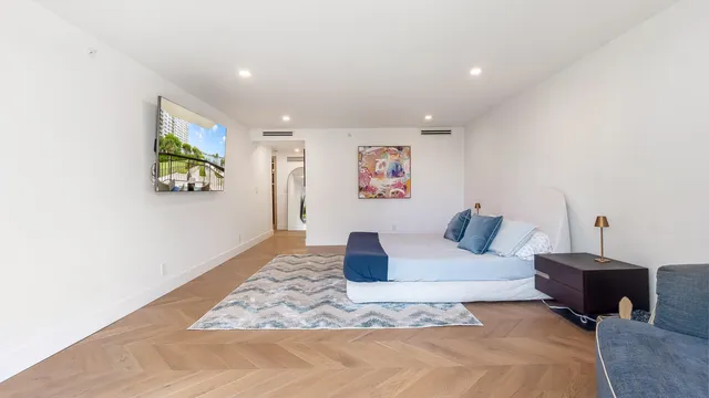 a spacious bedroom with a bed and a couch