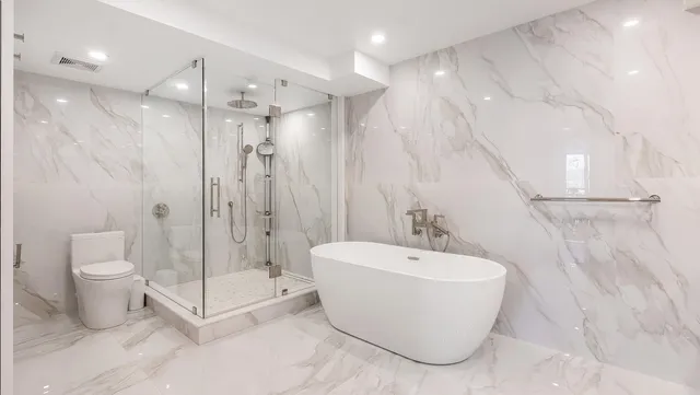 a bathroom with a bathtub and shower