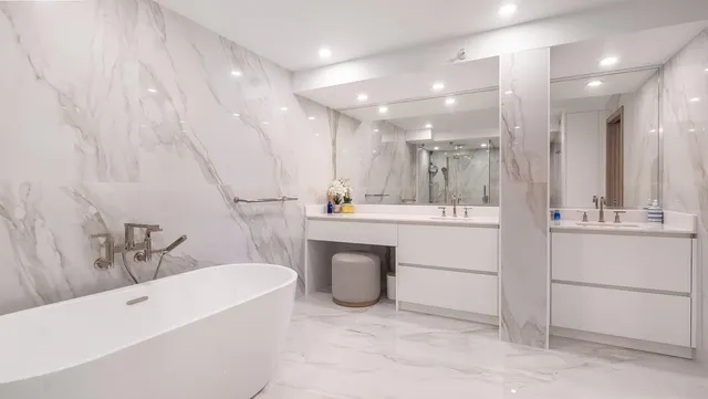 a bathroom with a bathtub sink a mirror and a shower