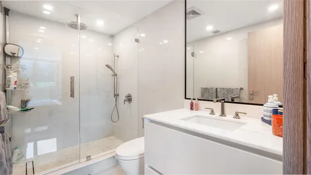 a bathroom with a sink toilet and shower