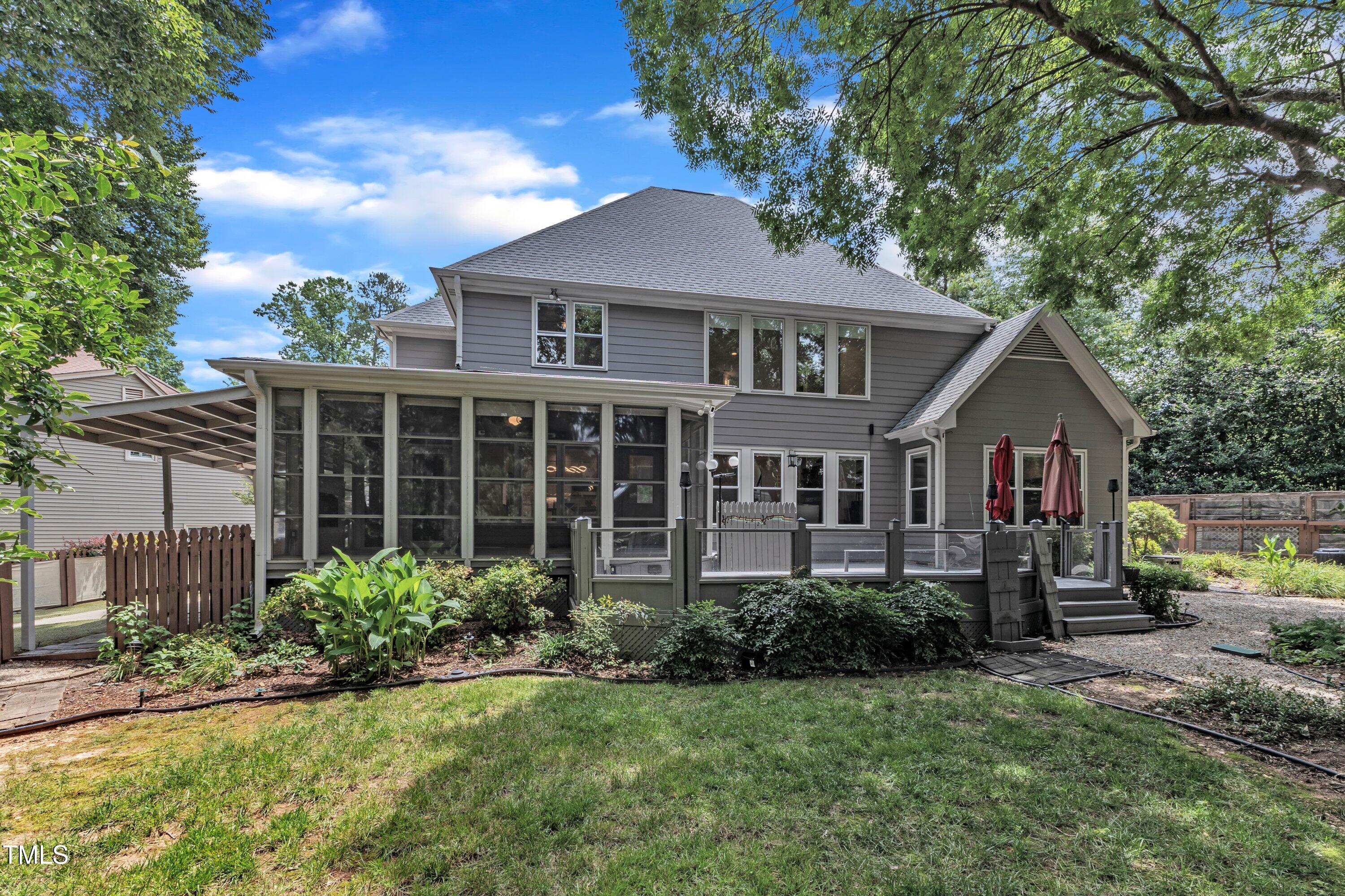 5309 Overtop Lane Raleigh, NC 27613 - Photo 54 of 63 a front view of a house with a yard and potted plants