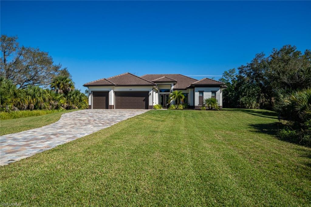 522 19th Street Northwest Naples, FL 34120 - Photo 1 of 33 a front view of a house with a garden