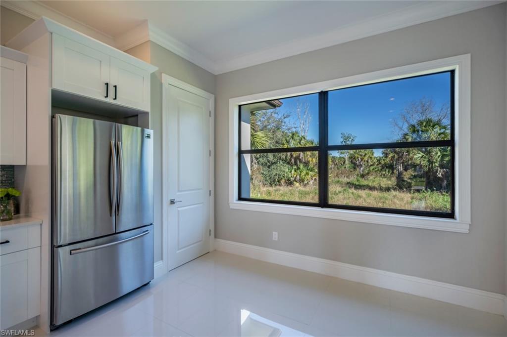 522 19th Street Northwest Naples, FL 34120 - Photo 13 of 33 a kitchen with stainless steel appliances a refrigerator and a window