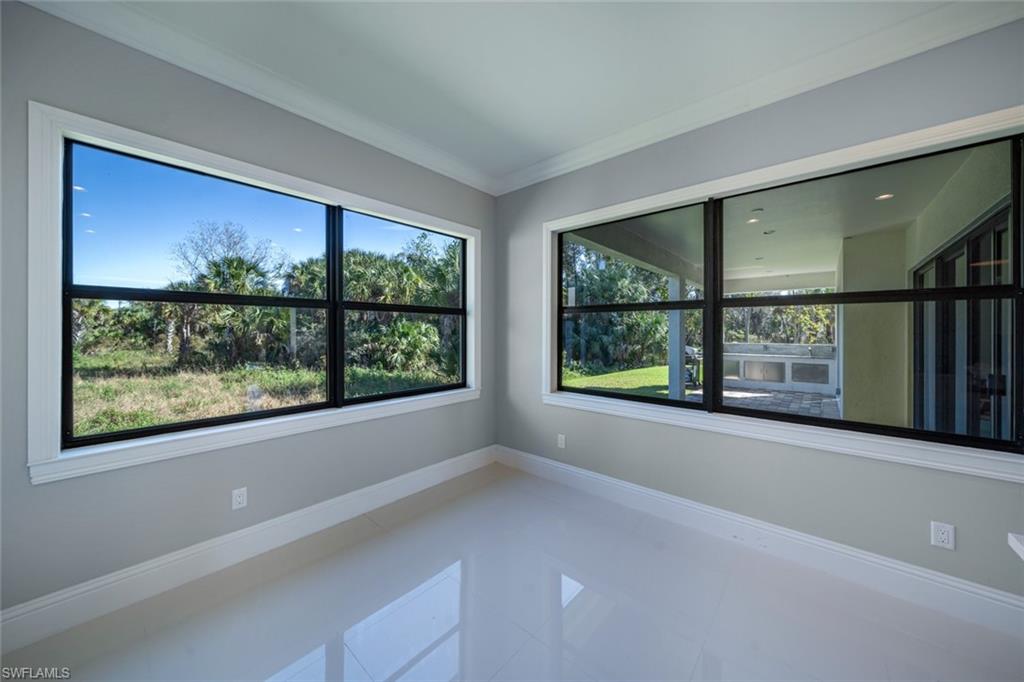 522 19th Street Northwest Naples, FL 34120 - Photo 14 of 33 an empty room with large windows