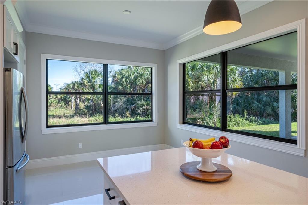 522 19th Street Northwest Naples, FL 34120 - Photo 15 of 33 a room with a window and dining area with wooden floor