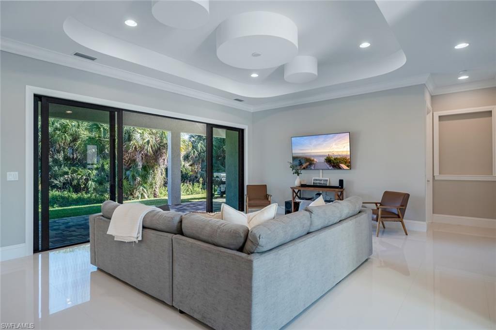 522 19th Street Northwest Naples, FL 34120 - Photo 16 of 33 a living room with furniture and a large window