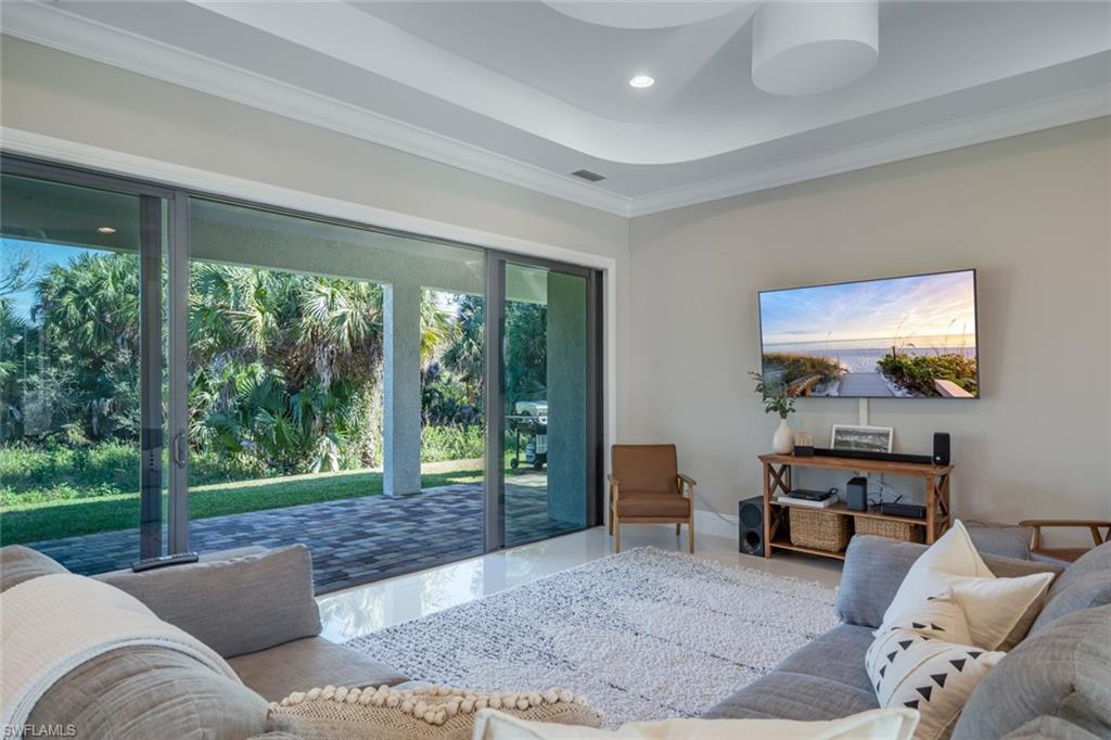 522 19th Street Northwest Naples, FL 34120 - Photo 17 of 33 a living room with furniture and a floor to ceiling window