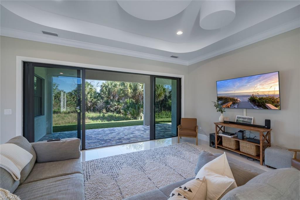522 19th Street Northwest Naples, FL 34120 - Photo 18 of 33 a living room with furniture and a flat screen tv