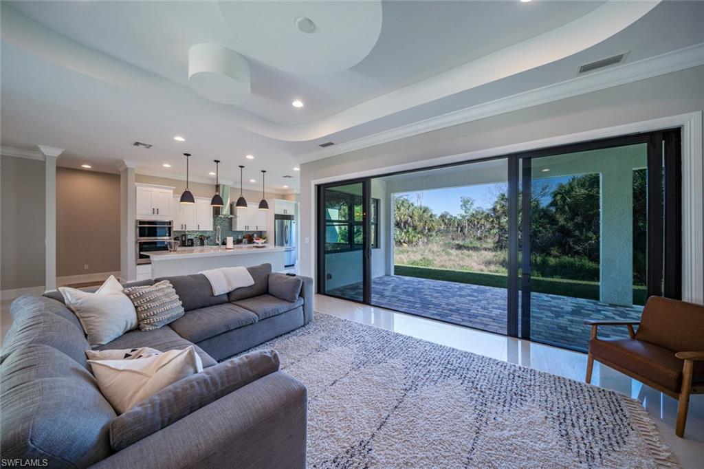 522 19th Street Northwest Naples, FL 34120 - Photo 19 of 33 a living room with furniture and a large window
