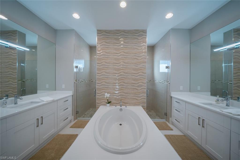 522 19th Street Northwest Naples, FL 34120 - Photo 20 of 33 a bathroom with a double vanity sink mirror and bathtub