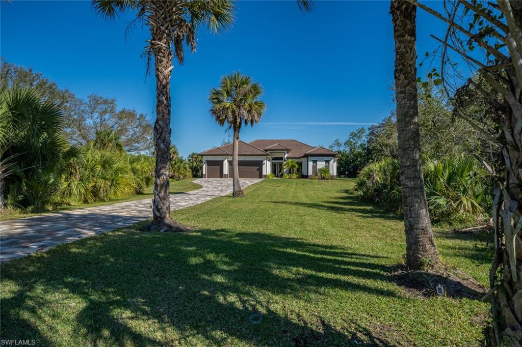 522 19th Street Northwest Naples, FL 34120 - Photo 2 of 33 a view of a house with a yard