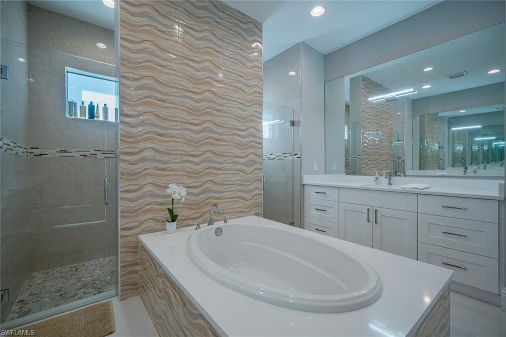 522 19th Street Northwest Naples, FL 34120 - Photo 21 of 33 a bathroom with a bathtub and a sink