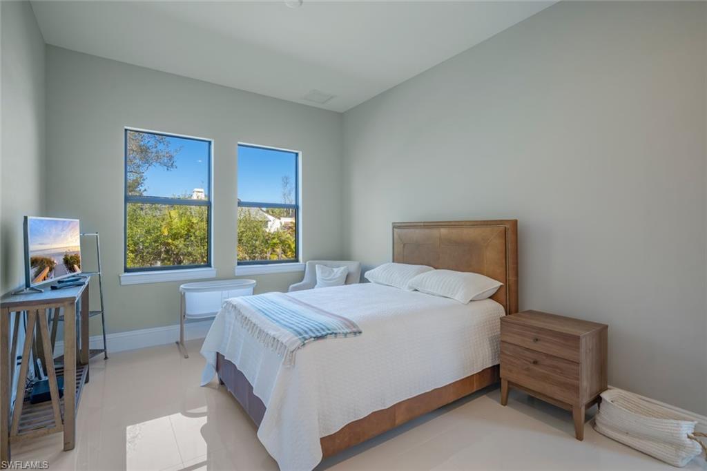 522 19th Street Northwest Naples, FL 34120 - Photo 24 of 33 a bedroom with a bed and a window