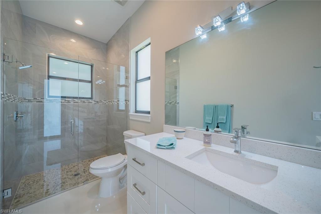 522 19th Street Northwest Naples, FL 34120 - Photo 25 of 33 a bathroom with a sink toilet and shower