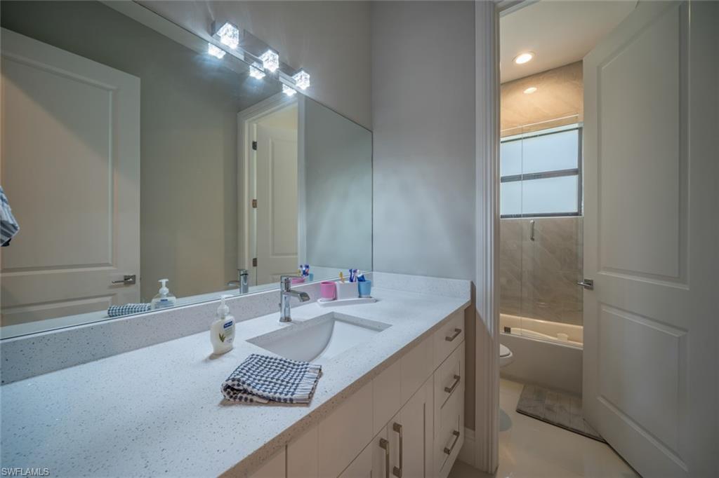 522 19th Street Northwest Naples, FL 34120 - Photo 28 of 33 a bathroom with a double vanity sink and a mirror