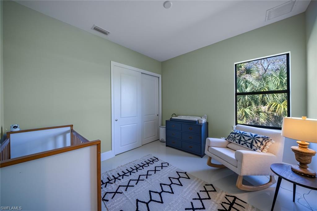 522 19th Street Northwest Naples, FL 34120 - Photo 29 of 33 a bedroom with furniture and a window