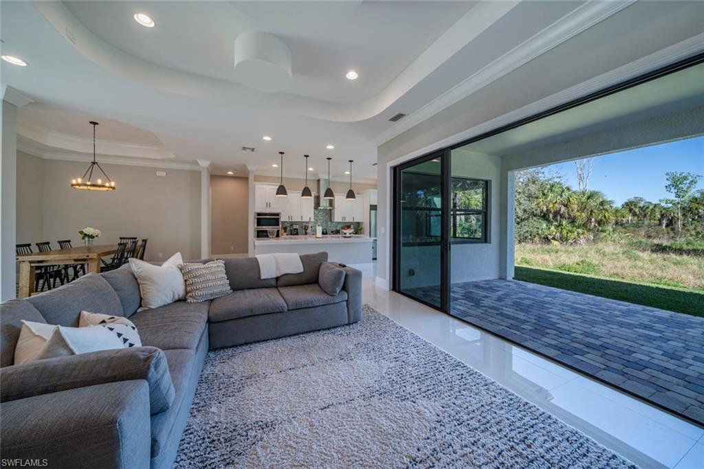 522 19th Street Northwest Naples, FL 34120 - Photo 30 of 33 a living room with furniture and a rug