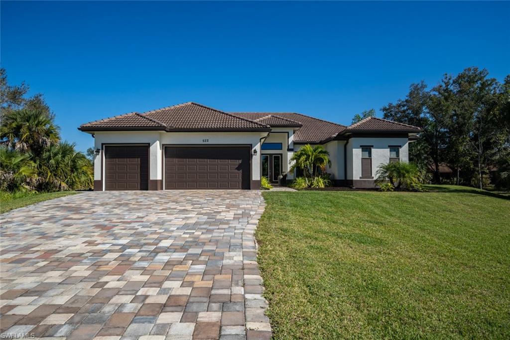 522 19th Street Northwest Naples, FL 34120 - Photo 6 of 33 a front view of a house with a garden