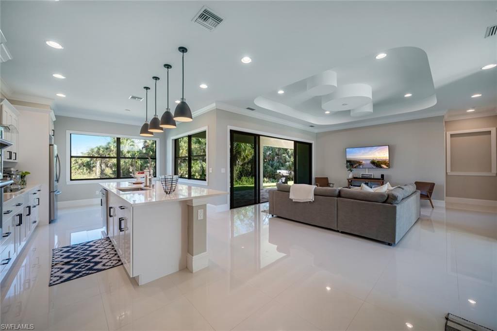 522 19th Street Northwest Naples, FL 34120 - Photo 9 of 33 a living room with furniture and a large window