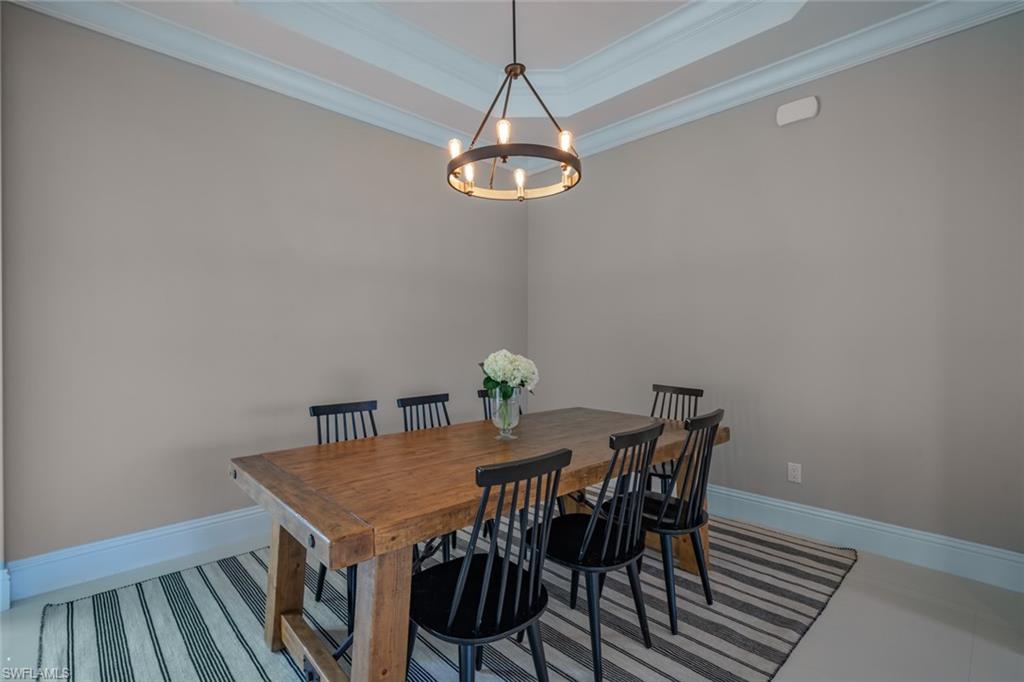 522 19th Street Northwest Naples, FL 34120 - Photo 10 of 33 a view of a dining room with furniture and wooden floor