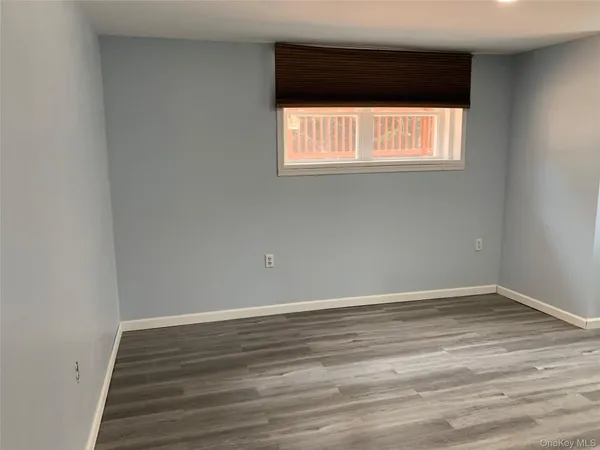 an empty room with wooden floor and closet