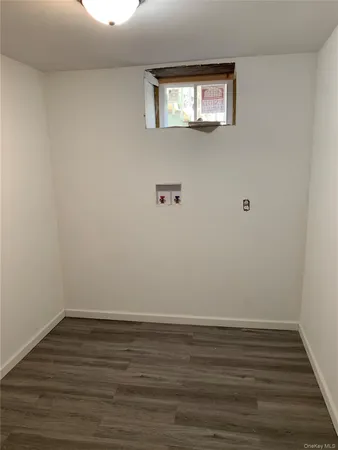a view of a room with wooden floor and windows
