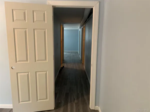 a view of a room with wooden floor and windows